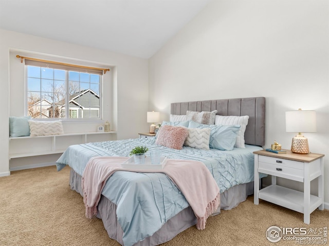 bedroom with lofted ceiling and carpet