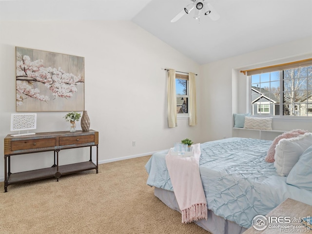 bedroom with carpet, baseboards, vaulted ceiling, and a ceiling fan