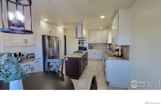 kitchen featuring a sink, stainless steel appliances, exhaust hood, and white cabinetry