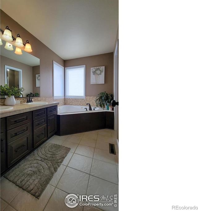 bathroom featuring vanity, a bath, visible vents, and tile patterned flooring