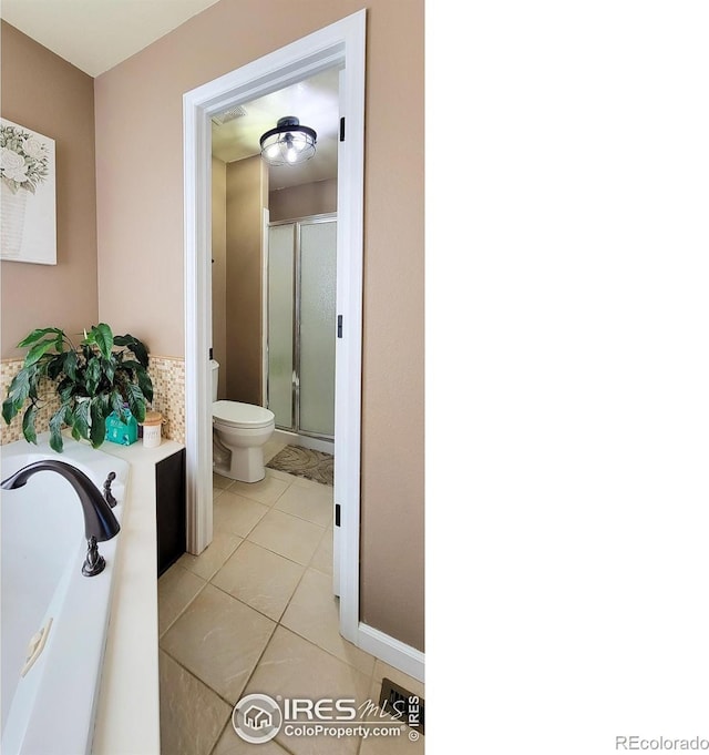 full bath with visible vents, a garden tub, toilet, a shower stall, and tile patterned flooring