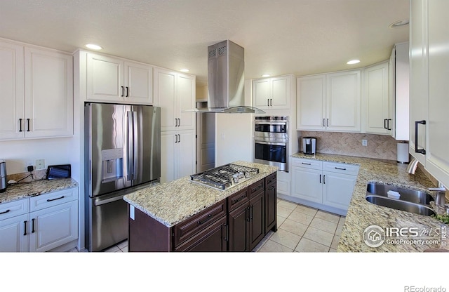 kitchen with a sink, appliances with stainless steel finishes, island range hood, and white cabinetry