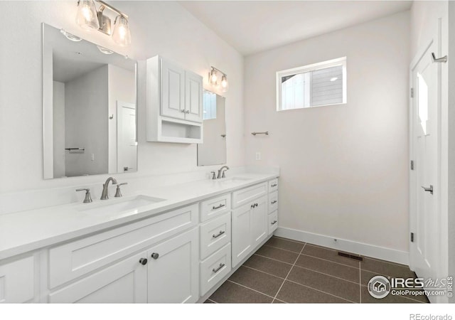 full bathroom with double vanity, visible vents, tile patterned floors, and a sink