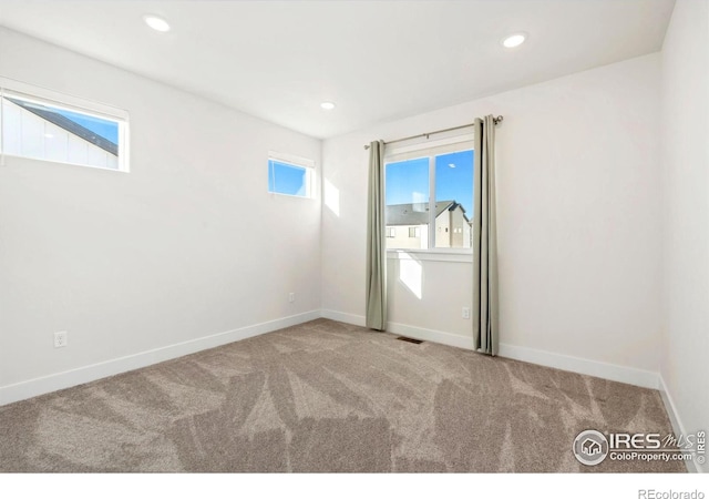 empty room with visible vents, carpet flooring, recessed lighting, and baseboards