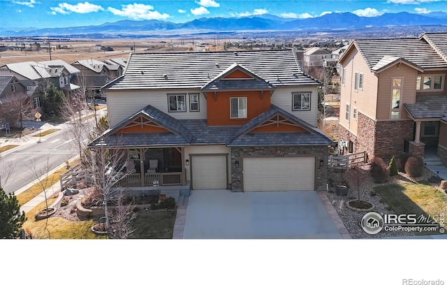 view of front of property with driveway, a residential view, and a mountain view