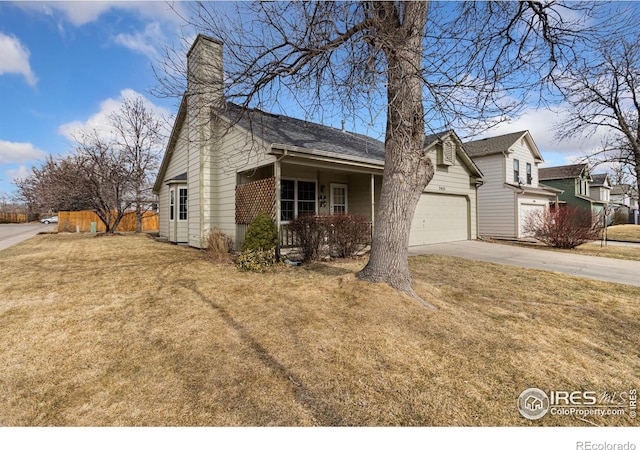 view of front of property with a garage, fence, driveway, a front lawn, and a chimney