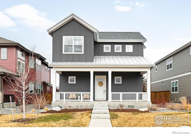 view of front of property with a standing seam roof, metal roof, a porch, and board and batten siding