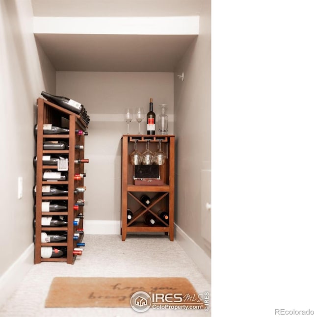 wine cellar featuring carpet and baseboards