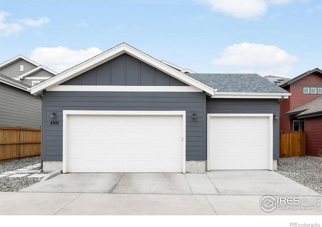 garage with fence and driveway