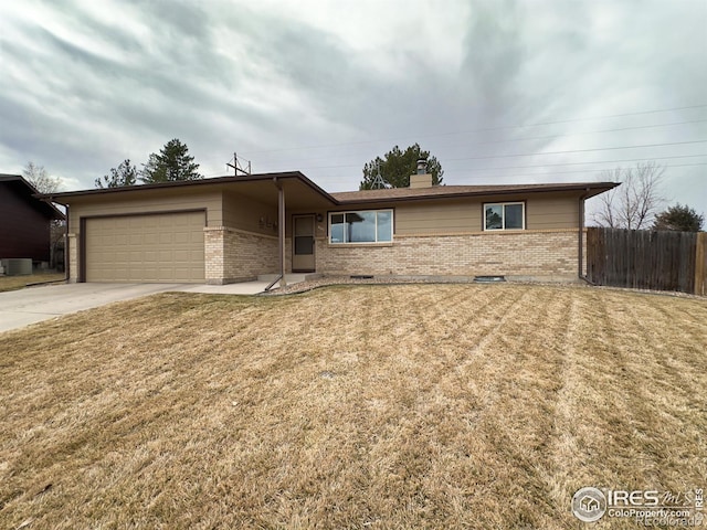 ranch-style house with a garage, concrete driveway, fence, a front yard, and brick siding