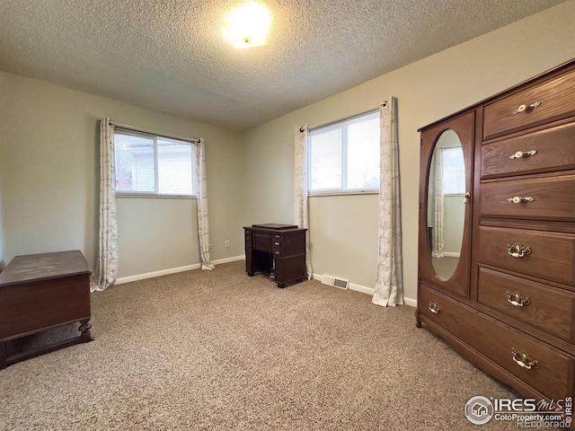 bedroom featuring carpet floors, visible vents, baseboards, and multiple windows