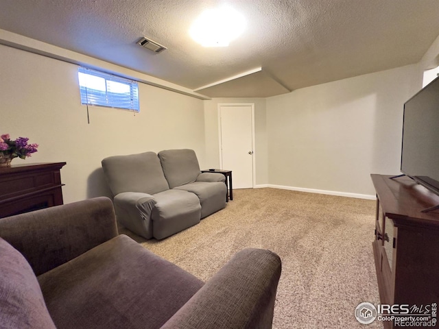 carpeted living area with visible vents, a textured ceiling, and baseboards