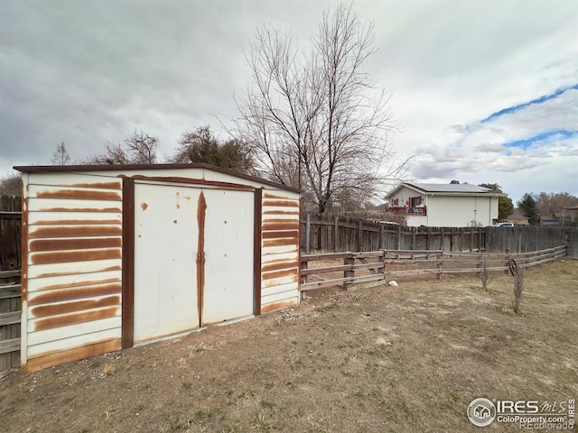 view of shed with a fenced backyard