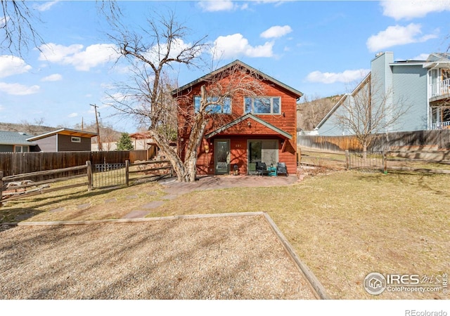 back of property featuring fence private yard and a yard