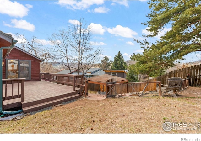 view of yard featuring fence and a deck