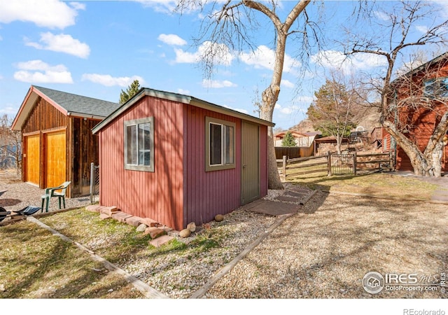 view of outbuilding with an outbuilding and fence