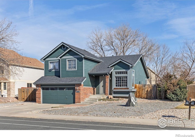 view of front of house with brick siding, fence, driveway, and an attached garage