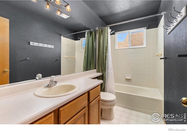 full bathroom with a textured wall, toilet, vanity, tile patterned floors, and shower / bathtub combination with curtain