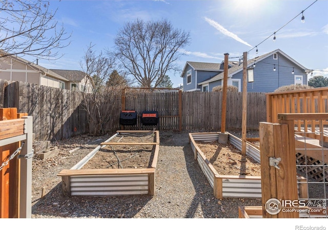 view of yard featuring a vegetable garden and fence