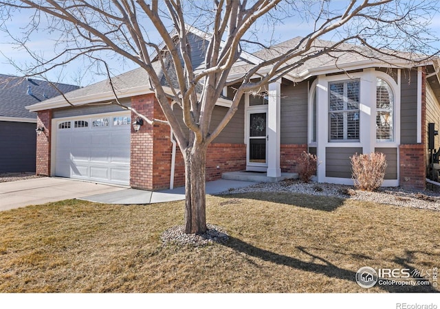 view of front of home with brick siding, a shingled roof, an attached garage, driveway, and a front lawn