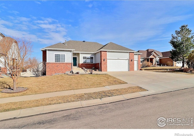 ranch-style home featuring a garage, concrete driveway, brick siding, and a front lawn