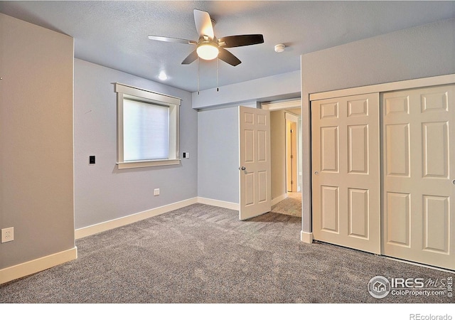 unfurnished bedroom featuring a closet, carpet, a ceiling fan, and baseboards