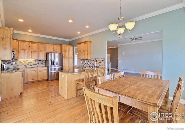 kitchen with light wood finished floors, visible vents, decorative backsplash, stainless steel fridge with ice dispenser, and a peninsula