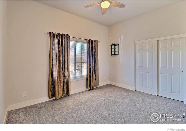 unfurnished bedroom featuring carpet floors, a closet, visible vents, a ceiling fan, and baseboards