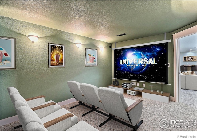 carpeted cinema featuring a textured ceiling, a textured wall, visible vents, and baseboards