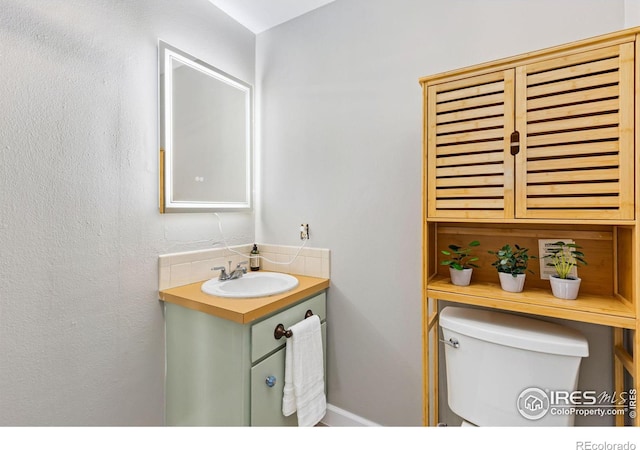 bathroom featuring toilet and vanity