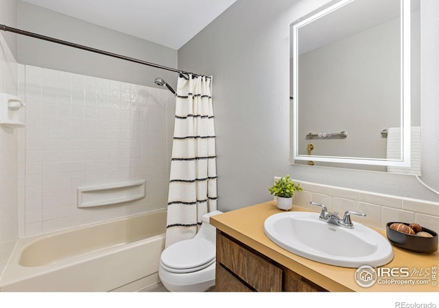 bathroom featuring shower / tub combo, vanity, and toilet