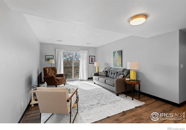 living area with baseboards and wood finished floors