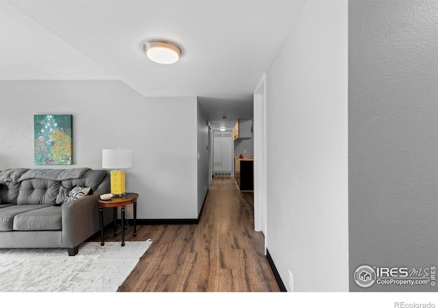 living room with baseboards and wood finished floors