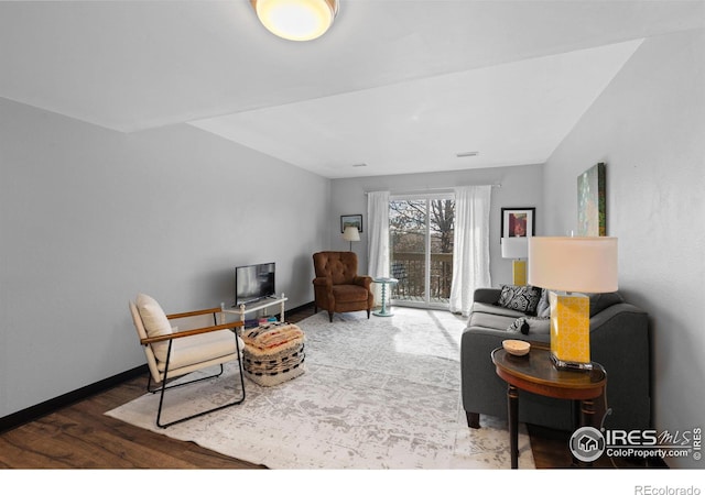 living room featuring wood finished floors and baseboards