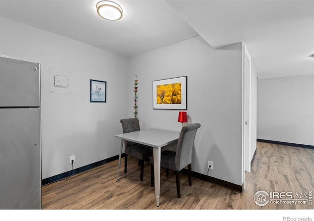 dining room featuring wood finished floors and baseboards