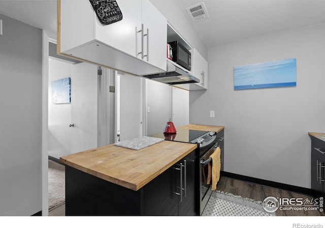 kitchen with visible vents, wood counters, black appliances, and white cabinetry