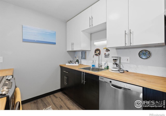 kitchen featuring stainless steel dishwasher, a sink, butcher block counters, and white cabinets