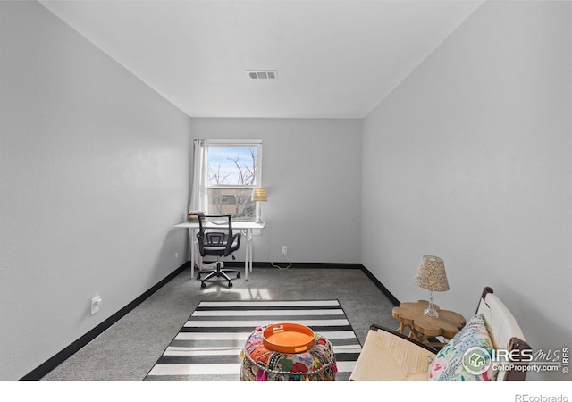 carpeted office space with visible vents and baseboards