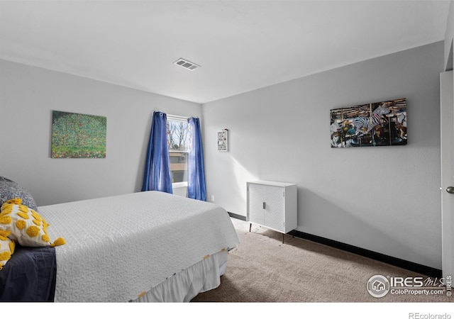 bedroom with carpet flooring, visible vents, and baseboards