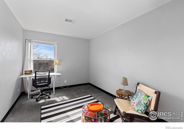 carpeted office space featuring visible vents and baseboards