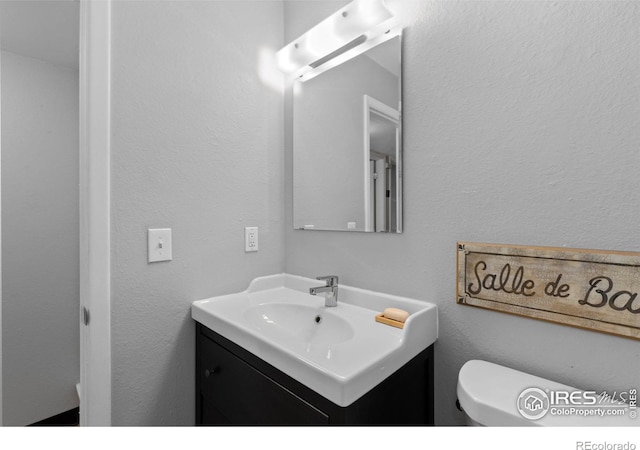 bathroom with toilet and vanity