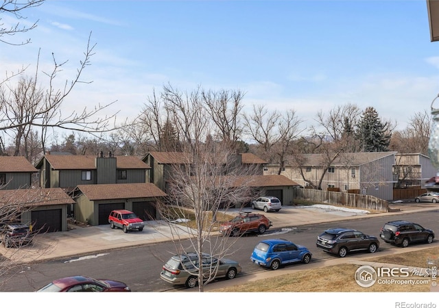 view of property with a garage and a residential view