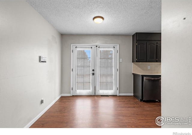 interior space featuring dark wood-style floors, baseboards, and french doors