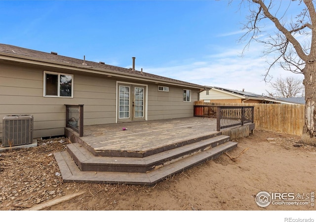 rear view of house with cooling unit, french doors, fence, and a deck