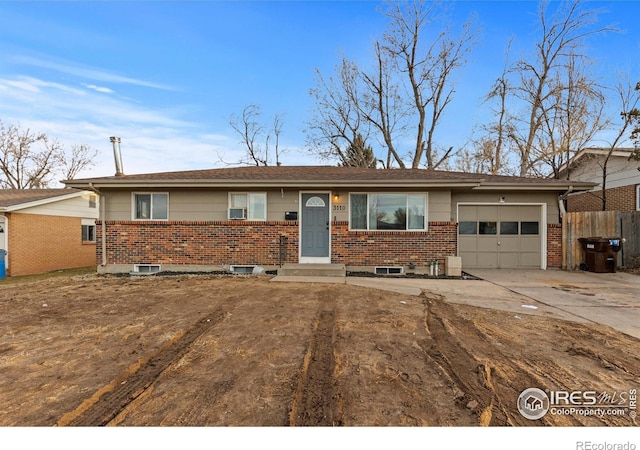 ranch-style house with a garage, fence, concrete driveway, and brick siding