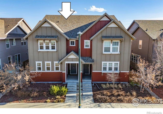 craftsman-style home featuring board and batten siding, brick siding, and a shingled roof