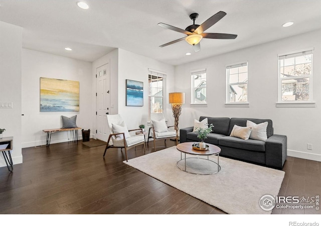 living room featuring recessed lighting and dark wood finished floors