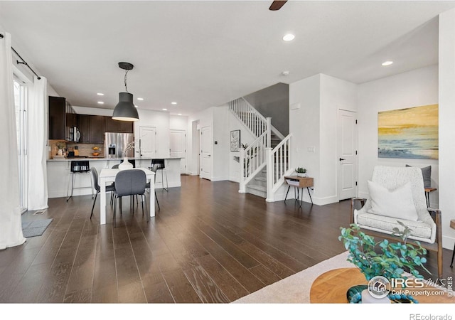 interior space featuring dark wood-type flooring, recessed lighting, stairway, and baseboards