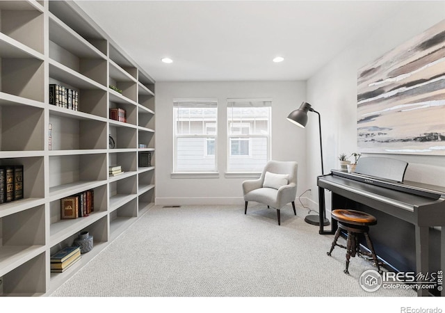 living area featuring carpet, baseboards, and recessed lighting