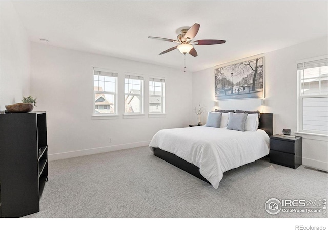 bedroom with a ceiling fan, carpet, visible vents, and baseboards